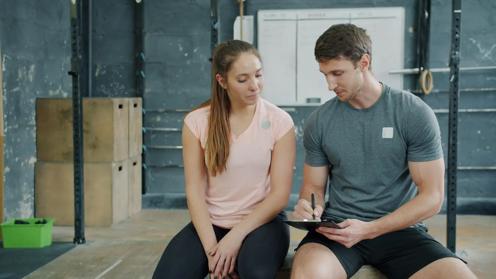 A personal trainer and client going through a plan together